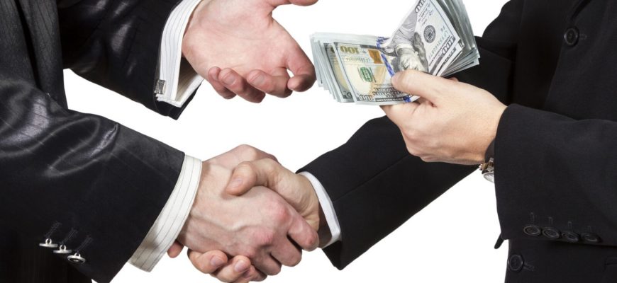 Handshake with the transfer of money